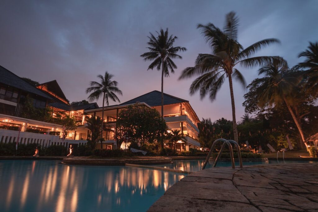 Crafting Captivating Headlines: Your awesome post title goes here Luxurious tropical resort with swimming pool and palms at dusk, perfect for a tranquil vacation.